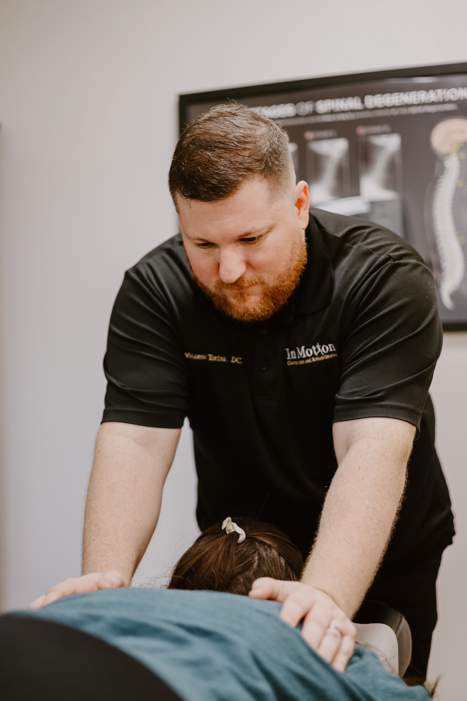 Dr. Torina delivering a chiropractic adjustment in the Oviedo office