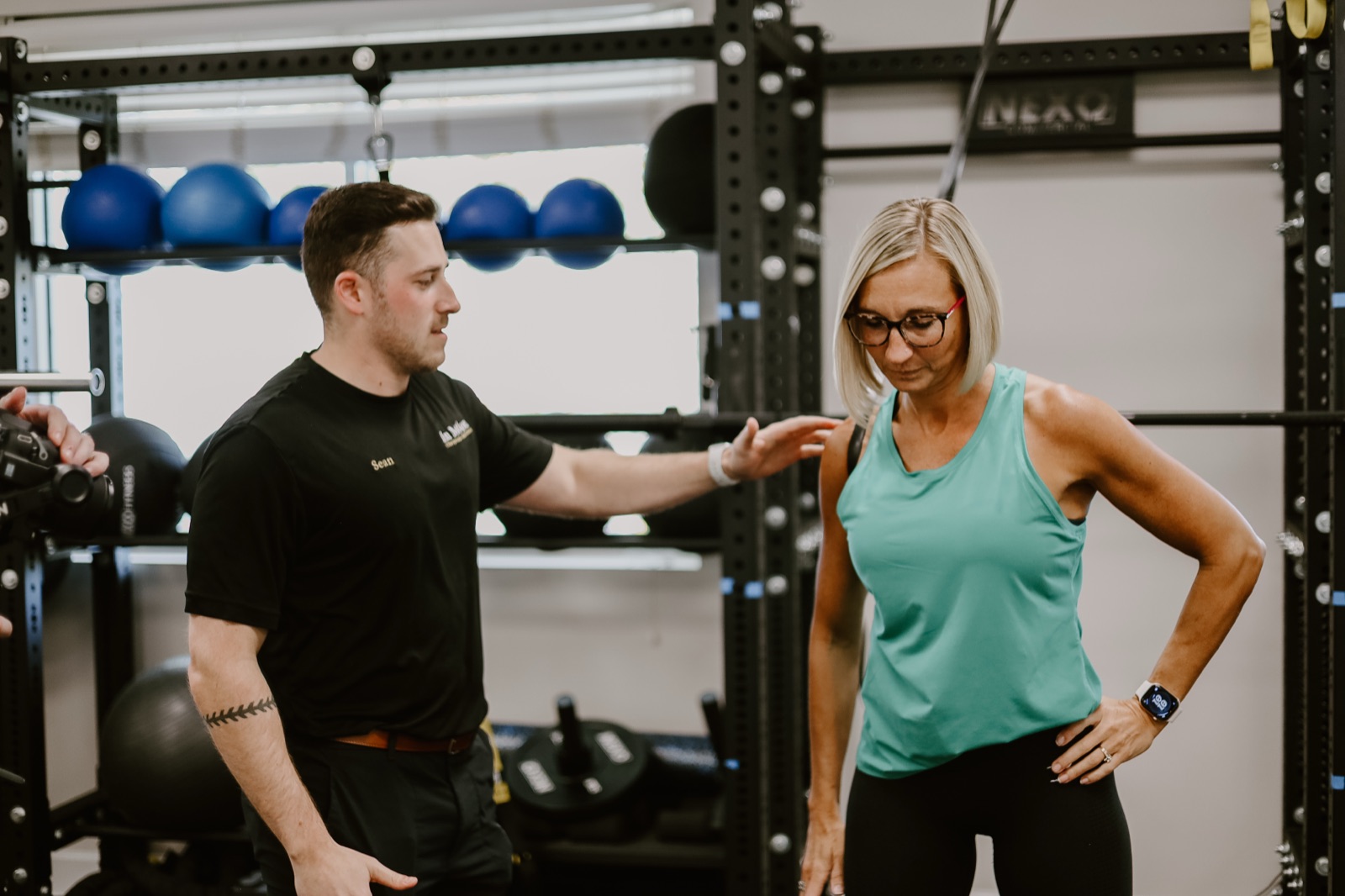 A patient coached through rehab exercise in the In Motion training gym