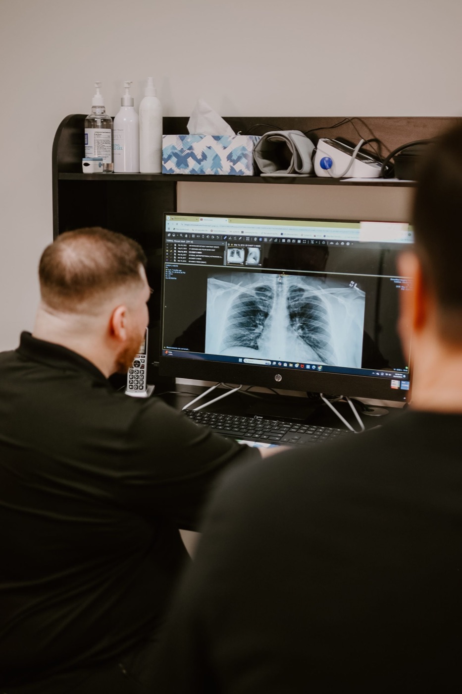 Dr. Torina reviewing spinal X-rays with a patient at In Motion in Oviedo, FL